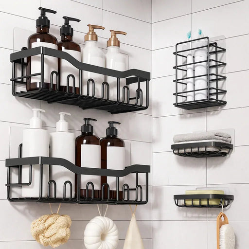 Adhesive black metal corner shower rack set installed in a white tiled modern bathroom, storing soap dispensers, towels, and bath sponges for organized storage